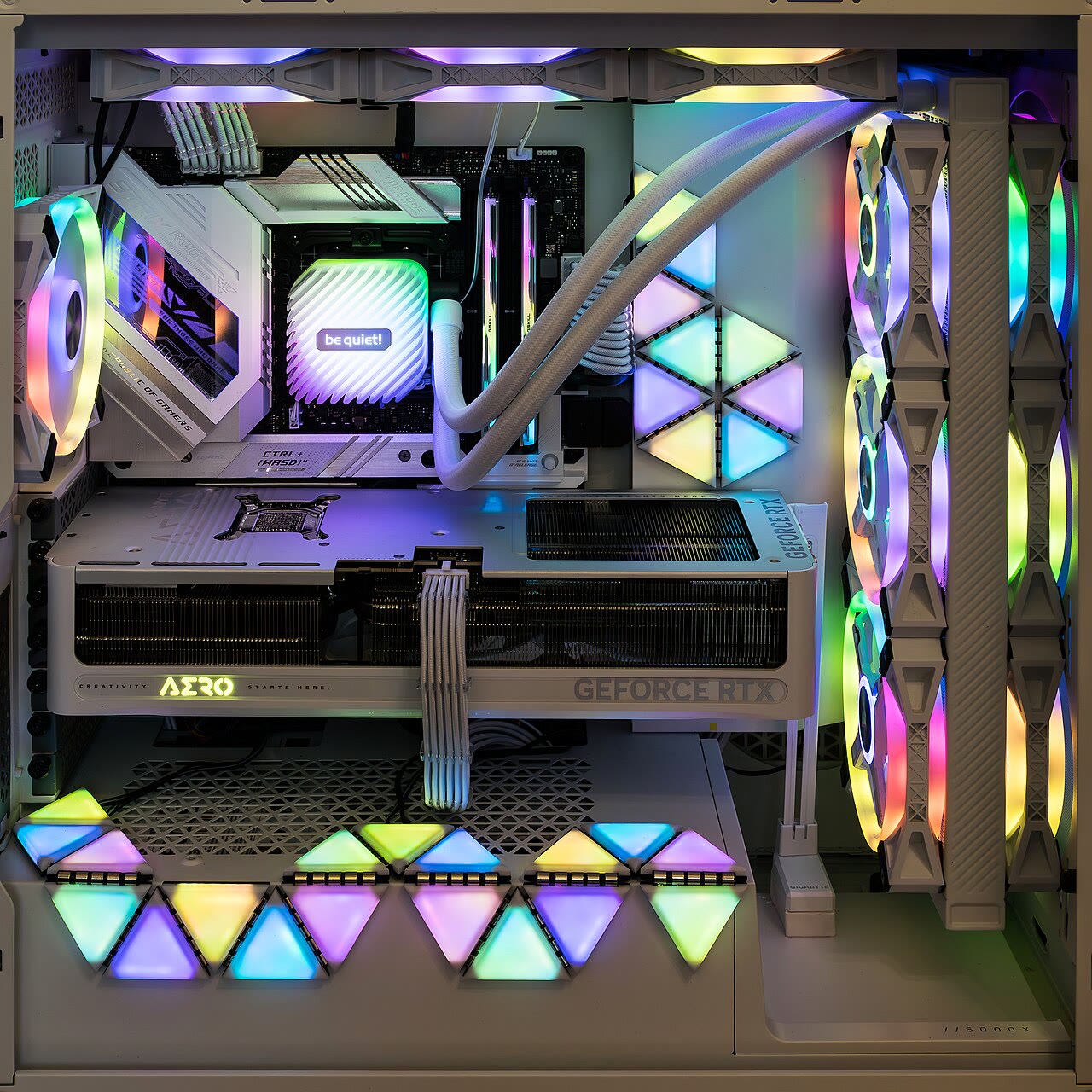 RGB-lit gaming PC interior with liquid cooling and illuminated fans